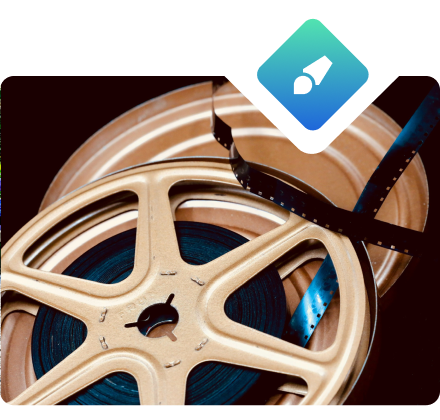 Vintage film reel with a strip of film draped across it